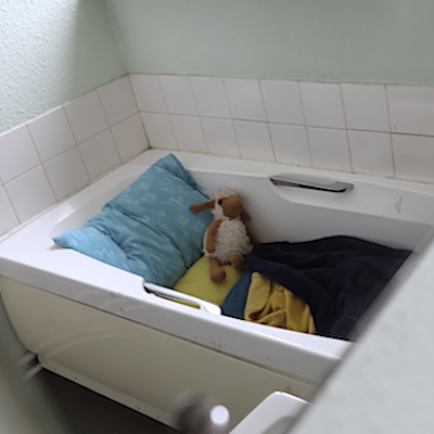 Childs make-shift bedding in a bath