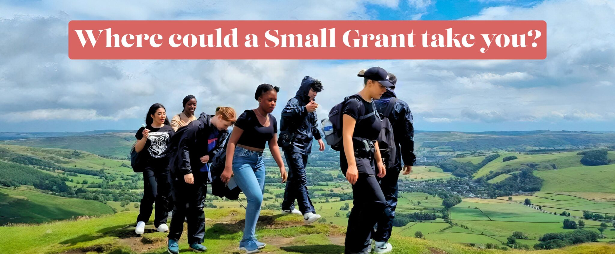 A group of young people walking through the countryside