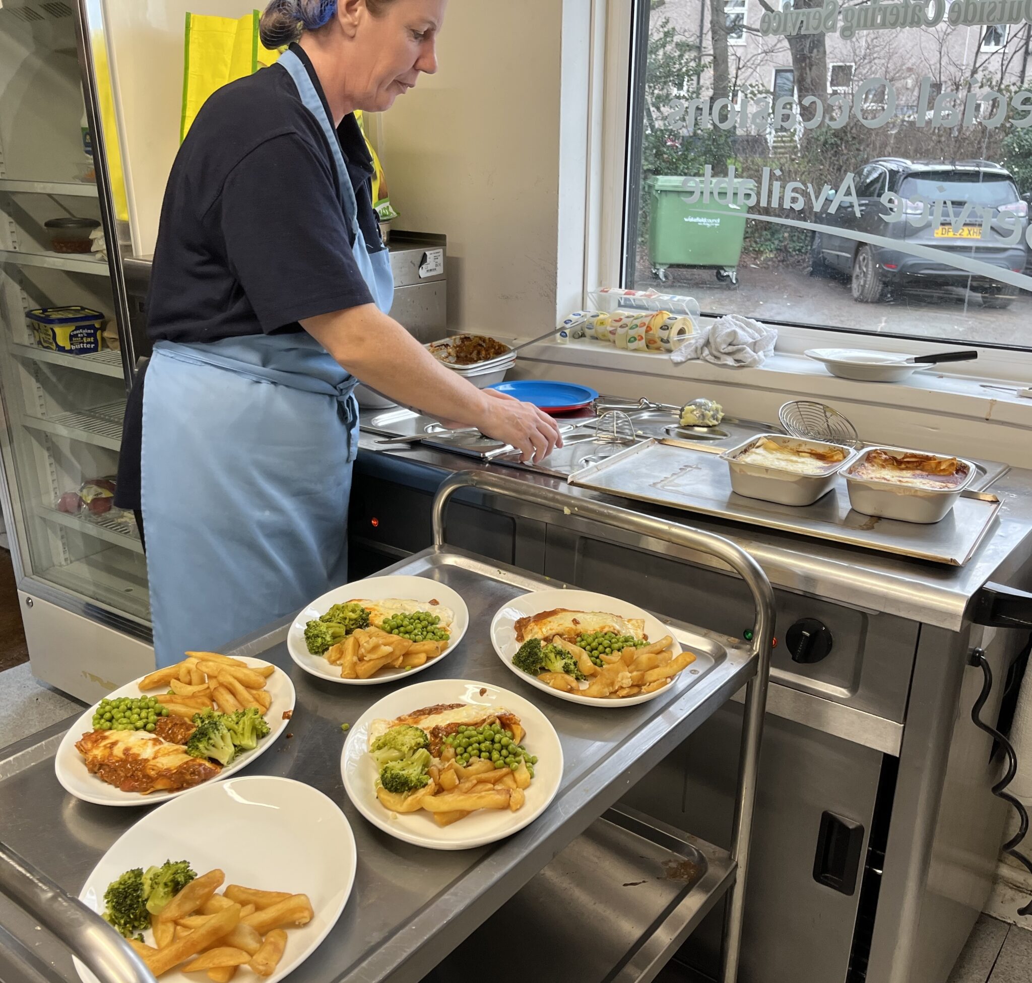 A chef plates up meals onto crockery