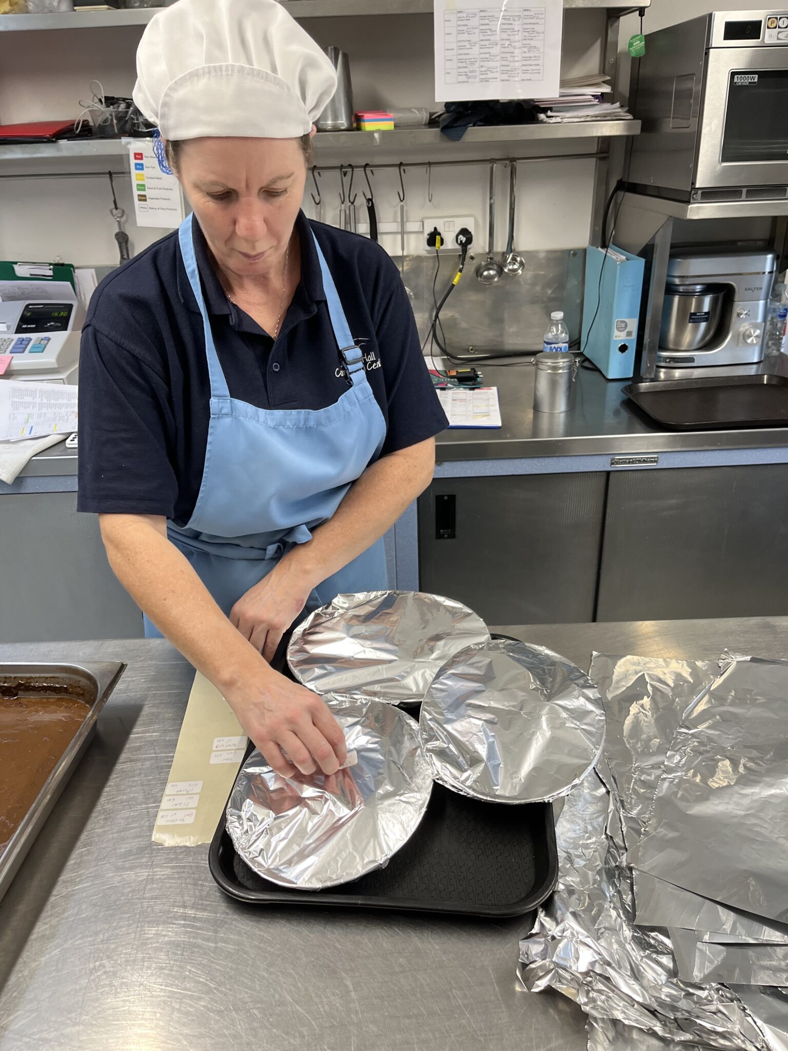 A chef wraps up meals ready for transporting